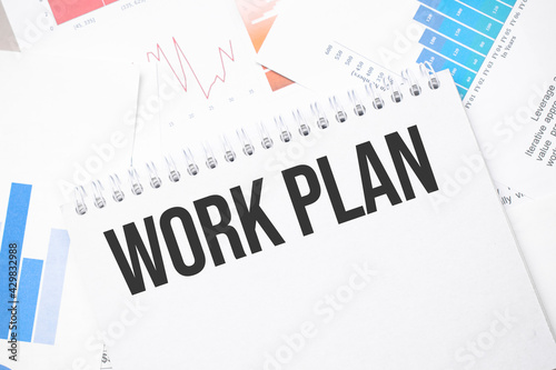 work plan text on paper on the chart background with pen