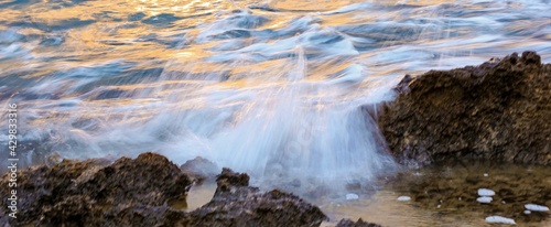 Blurred abstract natural background of sea water with waves and foam. Motion blur. Nature. Banner. © Татьяна