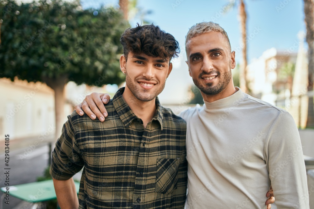 Young gay couple smiling happy and hugging at the city. Young gay couple smiling happy and hugging at the city.