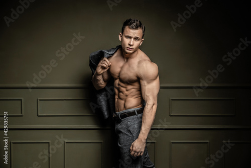 sexy muscular shirtless man in trousers lookini in camera photo