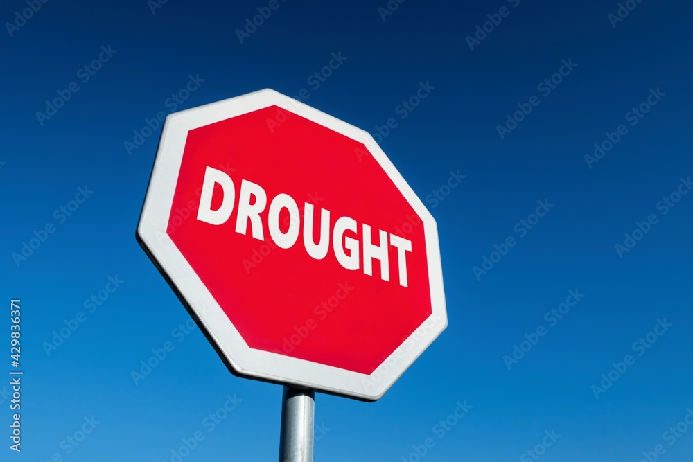 Traffic sign with the text DROUGHT to stop global warming, climate changes and dryness Traffic sign with the text DROUGHT to stop global warming, climate changes and dryness