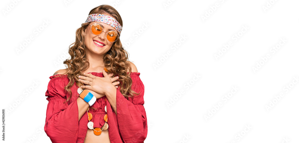 Young blonde girl wearing bohemian and hippie style smiling with hands on chest with closed eyes and grateful gesture on face. health concept.