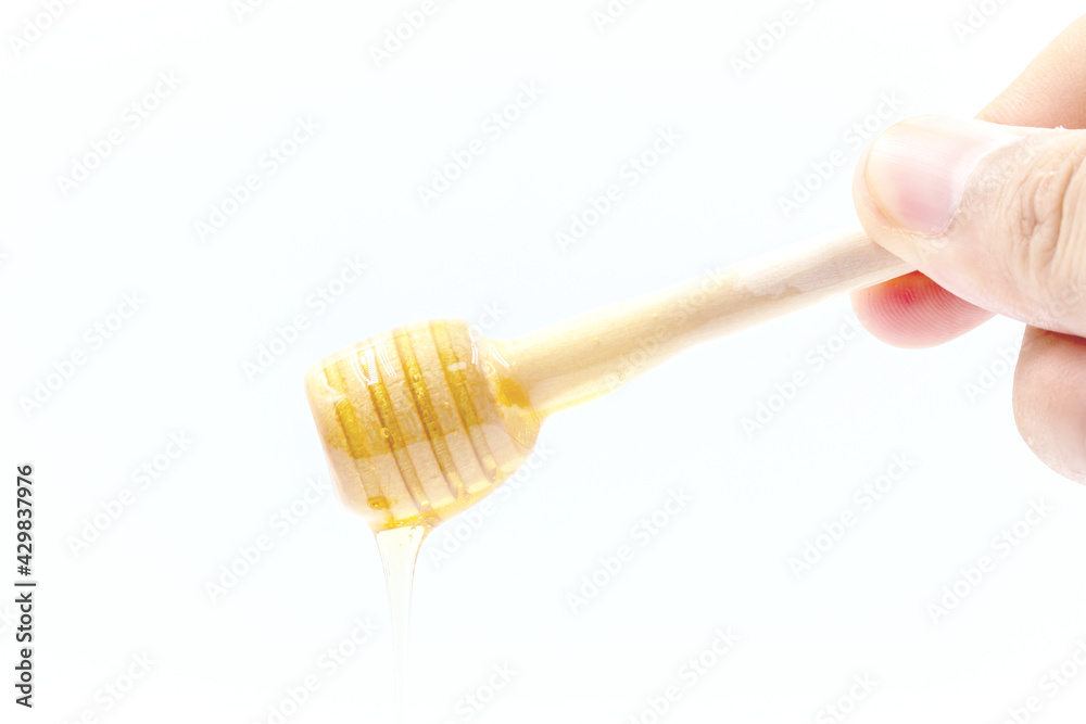 Hand held wooden honey ladle , isolated on white background