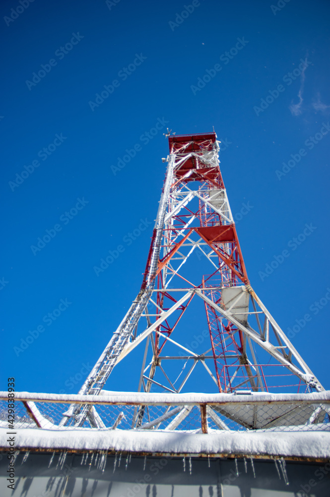 Tower with antennas connection in the mountains against the blue sky