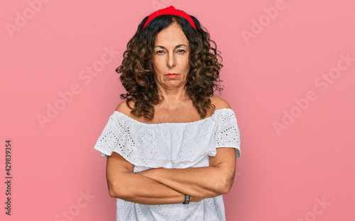 Принти на полотні Middle age hispanic woman wearing casual clothes skeptic and nervous, disapproving expression on face with crossed arms