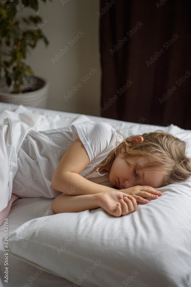 Lonely sad pensive girl lies on the bed. Children's emotions and experiences Lonely sad pensive girl lies on the bed. Children's emotions and experiences