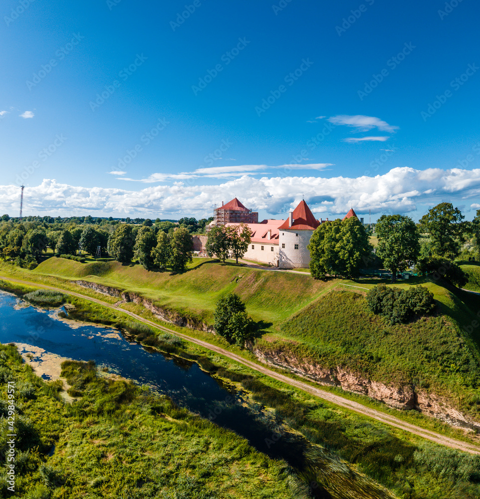 Aerial drone view over the Bauska medieval castle. Complex consisting of the ruins of an earlier castle and a later palace on the outskirts of the Latvian city of Bauska.