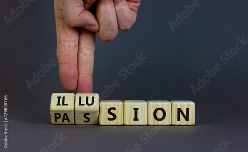 Illusion of passion symbol. Businessman turns wooden cubes and changes the word 'illusion' to 'passion'. Beautiful grey table, grey background, copy space. Business, and illusion of passion concept.
