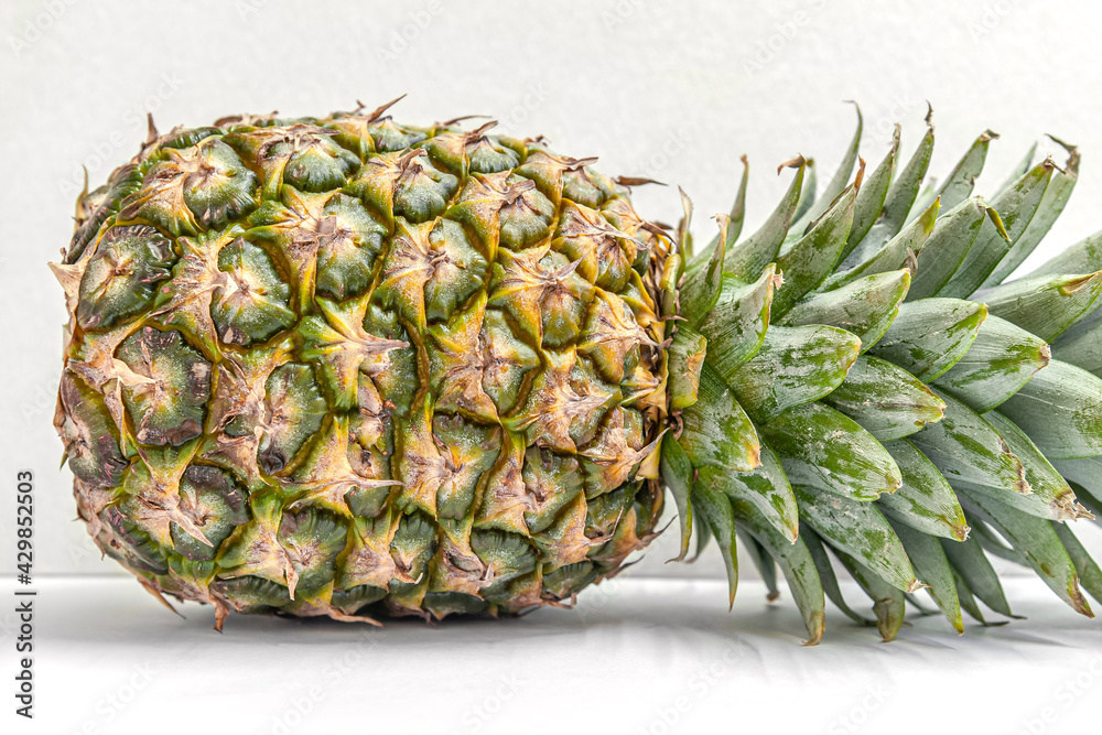 ripe juicy flavorful pineapple on a white table ripe juicy flavorful pineapple on a white table