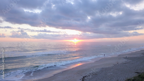 Lone fisherman ocean sunrise