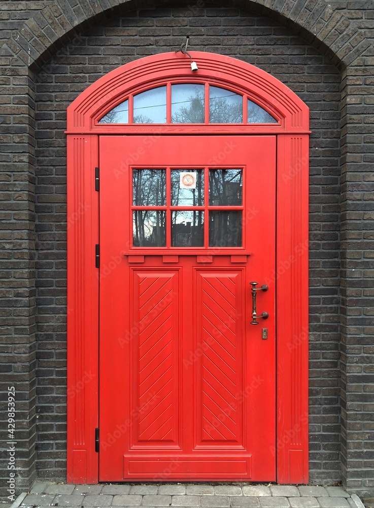 Beautiful red door in a brick wall Beautiful red door in a brick wall