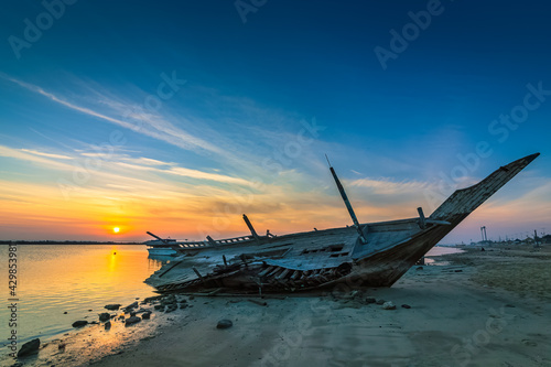 A broken old wooden fishing boat abandoned at Dammam Corniche, Kingdom of Saudi Arabia. © AFZALKHAN
