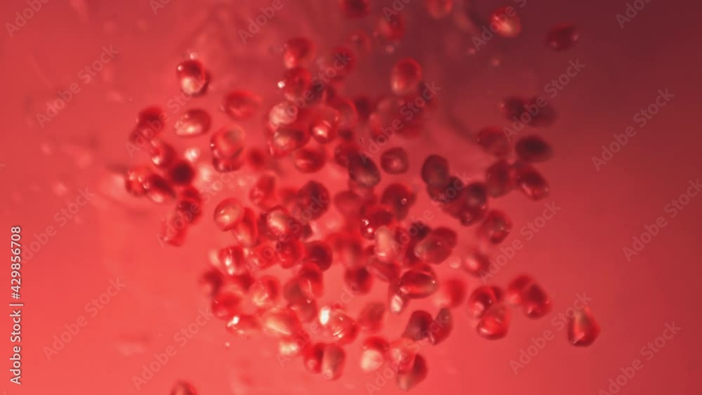 Super slow motion grain is a pomegranate with water droplets. On a red background. Filmed on a high-speed camera at 1000 fps. High quality FullHD footage Super slow motion grain is a pomegranate with water droplets. On a red background. Filmed on a high-speed camera at 1000 fps. High quality FullHD footage