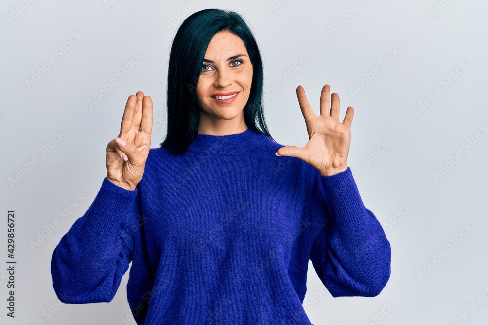Young caucasian woman wearing casual clothes showing and pointing up with fingers number eight while smiling confident and happy. Young caucasian woman wearing casual clothes showing and pointing up with fingers number eight while smiling confident and happy.