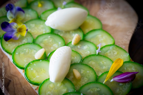 sliced cucumbers toast appetizer with pine nuts