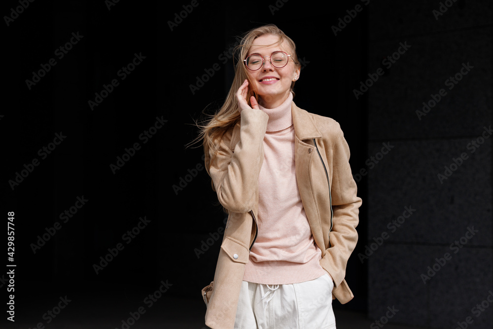 Blonde in glasses smiling in the sun Blonde in glasses smiling in the sun