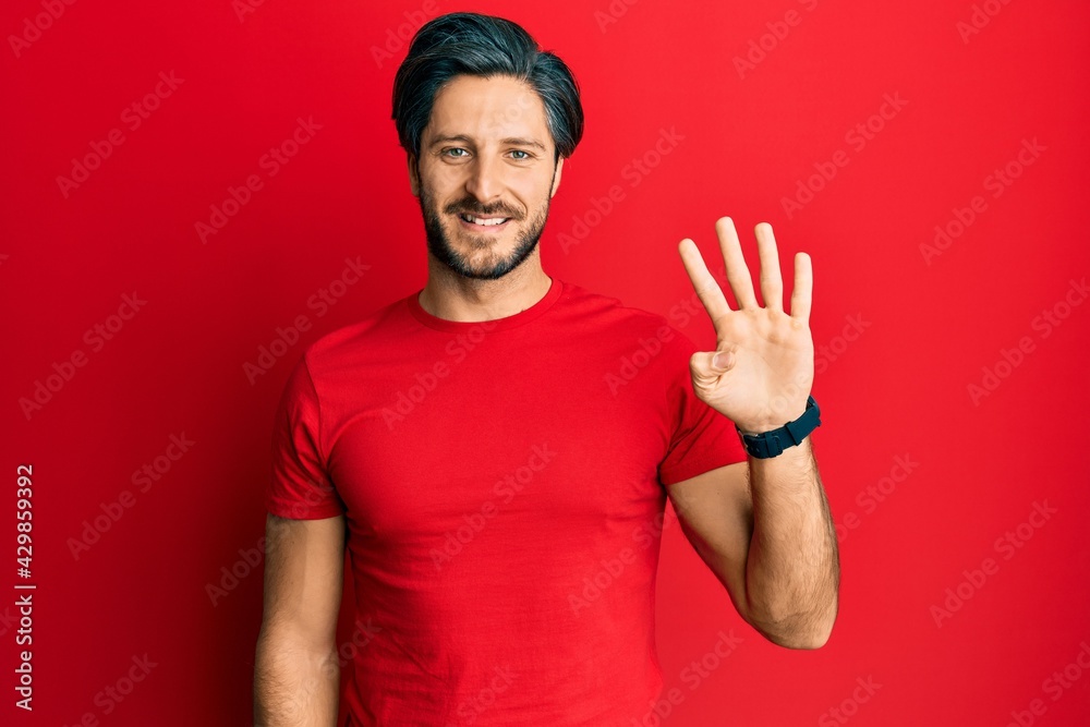 Young hispanic man wearing casual red t shirt showing and pointing up with fingers number four while smiling confident and happy. Young hispanic man wearing casual red t shirt showing and pointing up with fingers number four while smiling confident and happy.