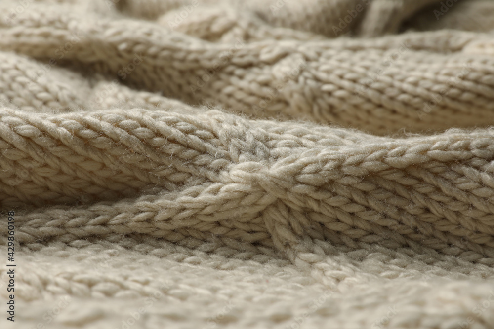 Beige knitted wool texture as background, closeup Beige knitted wool texture as background, closeup