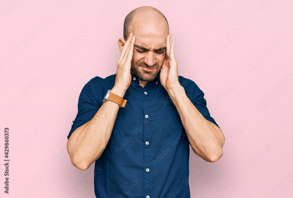Young hispanic man wearing casual clothes with hand on head, headache because stress. suffering migraine. Young hispanic man wearing casual clothes with hand on head, headache because stress. suffering migraine.