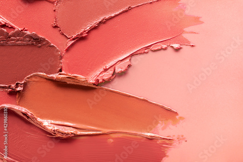 Fotografie Red orange brown lipstick background texture smudged sample swatch