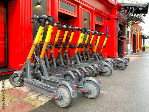 Parking of electric scooters near the train station photo