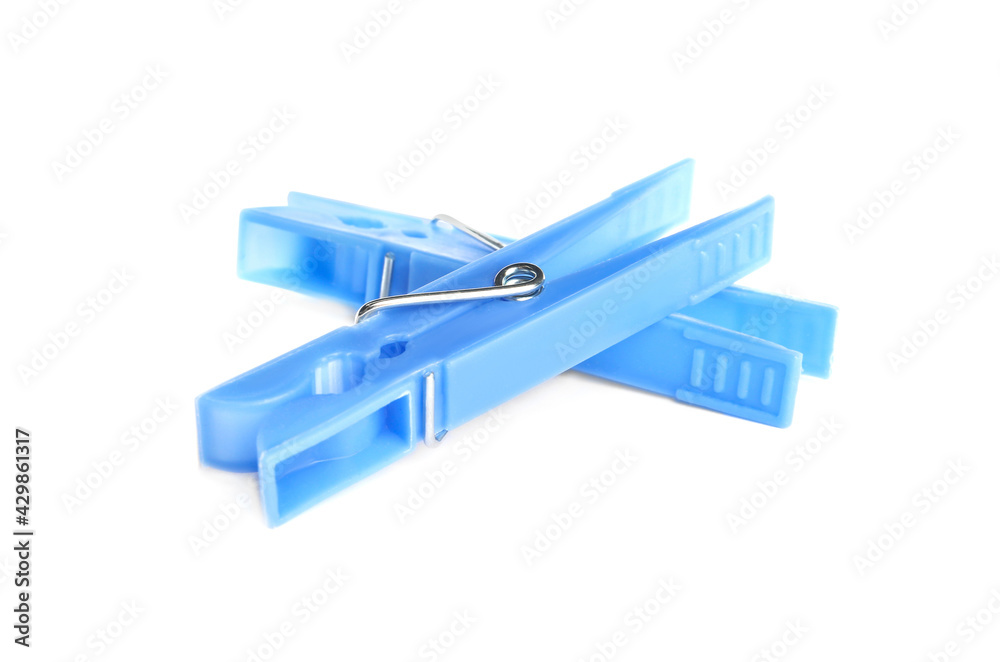 Light blue plastic clothespins on white background Light blue plastic clothespins on white background