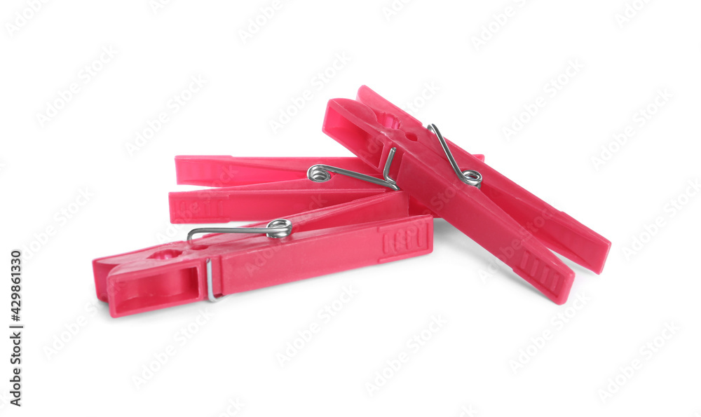 Bright pink plastic clothespins on white background Bright pink plastic clothespins on white background
