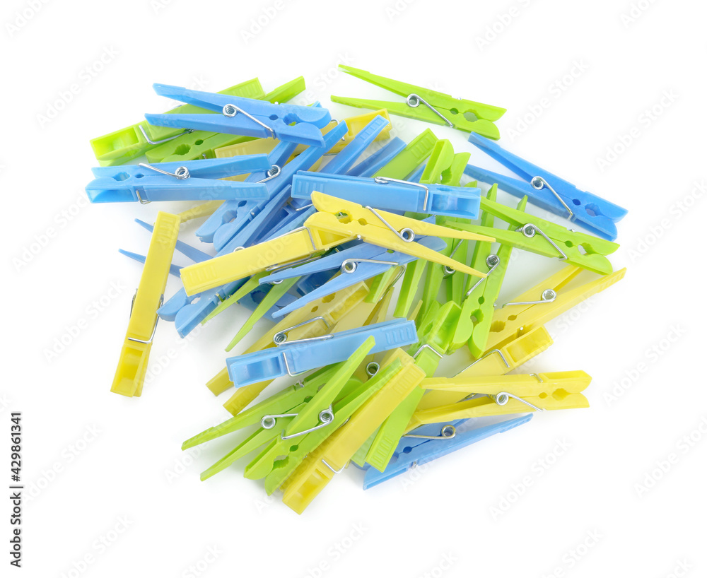 Colorful plastic clothespins on white background, top view
