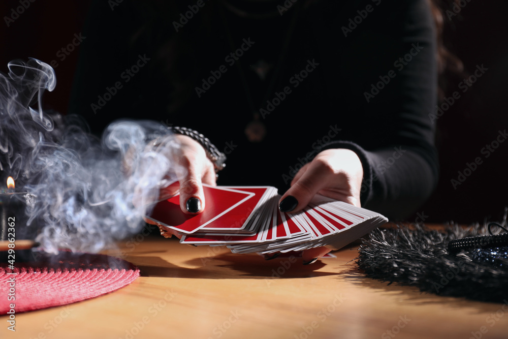 Soothsayer predicting future with cards at table indoors, closeup - obrazy, fototapety, plakaty 