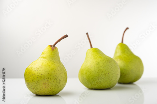 Pear, pakkham varieties, on a light background, with reflection