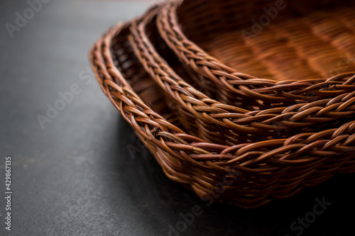 Some brown handmade baskets on a black wooden table 