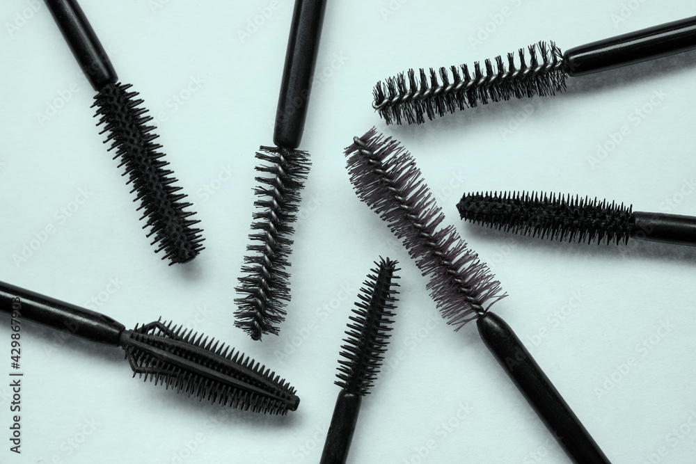 Assortment of brushes of black mascara texture