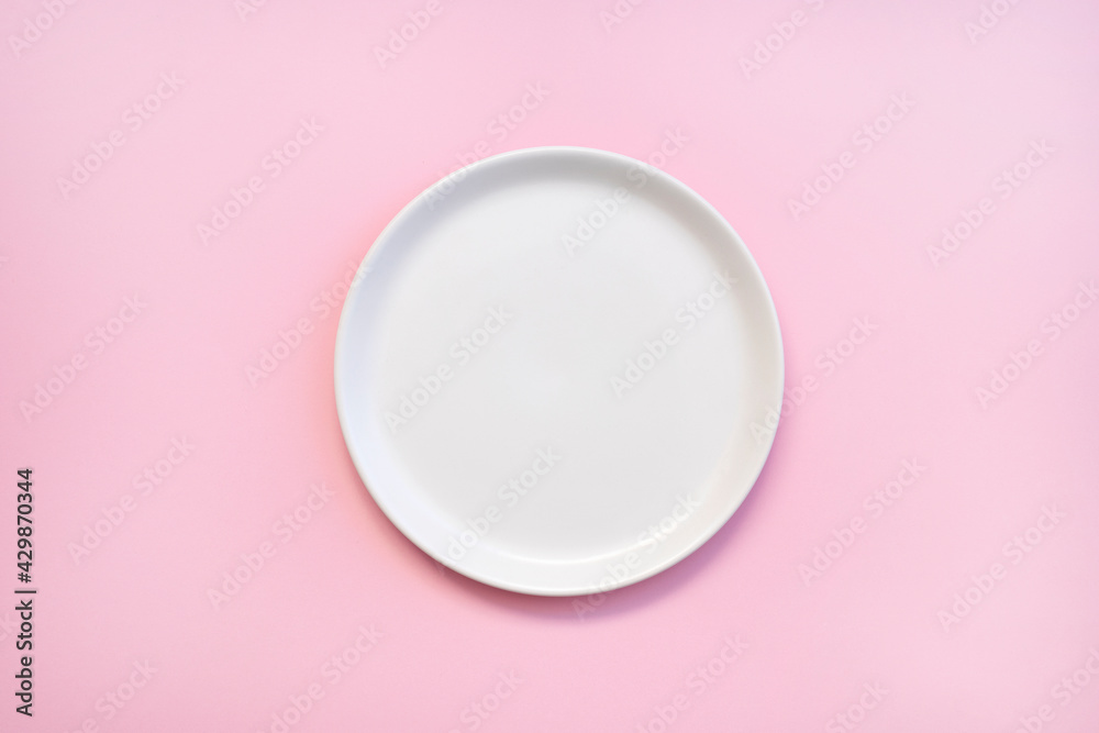 white empty plate on pink background, top view white empty plate on pink background, top view