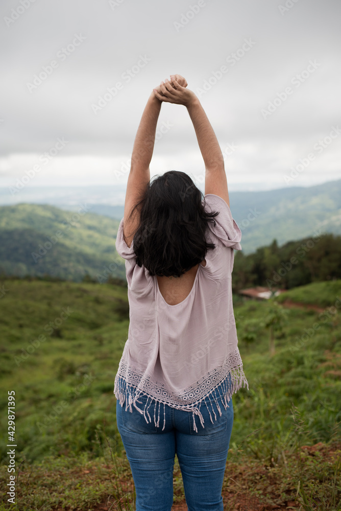 woman looking at the horizon in the field, woman in the mountains. woman looking at the horizon in the field, woman in the mountains.