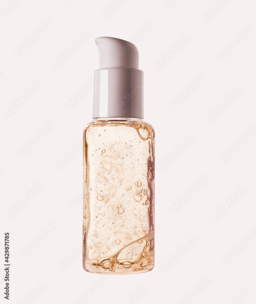 Cosmetic serum bottle sample on cold green blue background Cosmetic serum bottle sample on cold green blue background