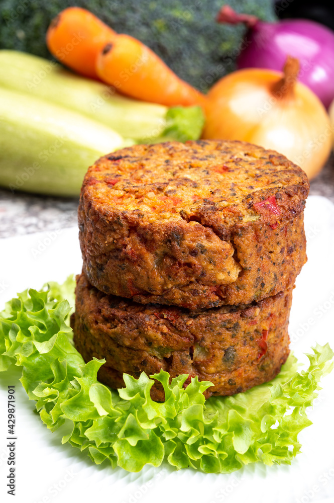 Round vegetarian patties or burgers made from grains, vegetables and legumes Round vegetarian patties or burgers made from grains, vegetables and legumes