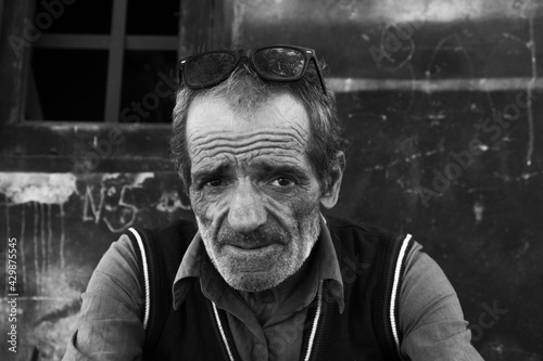 Portrait of a Georgian man. The worker takes a break and rests in the air. The expressive eyes of a wise man, the tired look of an elderly man. Day. Fall. Georgia.