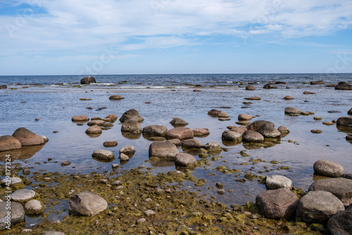 empty sandy beach by the sea with rocks