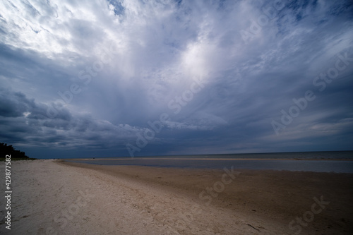 empty sandy beach by the sea with rocks