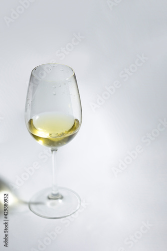 Light wine on white background. Glass with alcohol mockup for posters and product promo.
