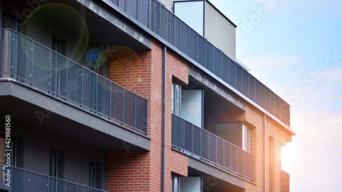 Architectural details of modern apartment building. Modern european residential apartment building complex with sunlight.