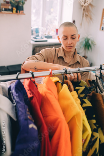 Woman looking at the clothes while parsing the wardrobe at home at the morning