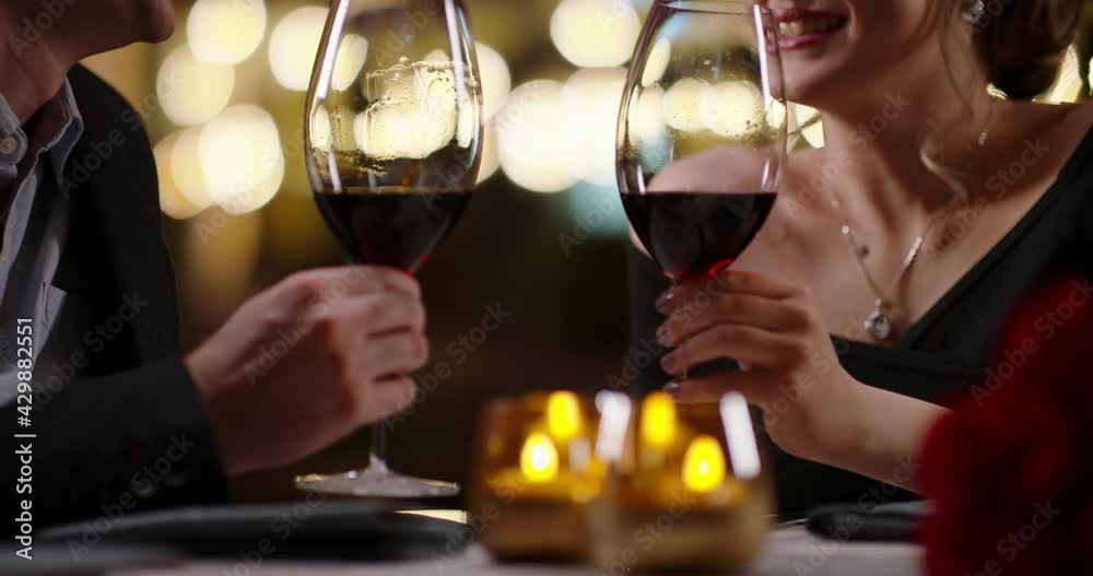 Caucasian couple on romantic date. Happy people are chatting during dinner in restaurant and drinking wine. Couple in love enjoying their time together 4k footage Caucasian couple on romantic date. Happy people are chatting during dinner in restaurant and drinking wine. Couple in love enjoying their time together 4k footage