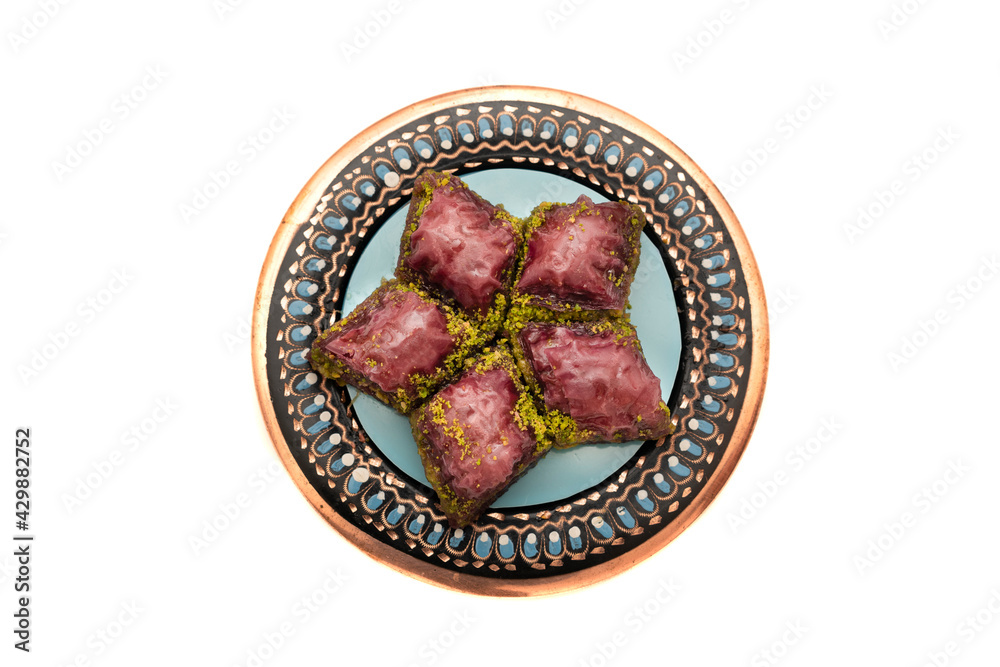 Obraz premium Closeup of traditional Turkish dessert - baklava (violet baklava) isolated on white background. Most popular dessert in Ramadan time (Turkish: Ramazan bayrami).