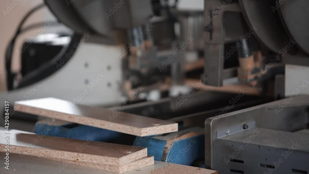 Conveyor machine for the production of furniture made of chipboard. Technological process of production automation. Close-up of working mechanisms Conveyor machine for the production of furniture made of chipboard. Technological process of production automation. Close-up of working mechanisms