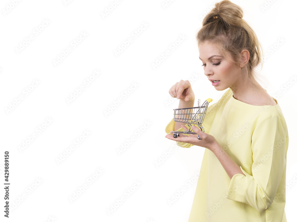 Woman holding small shopping cart
