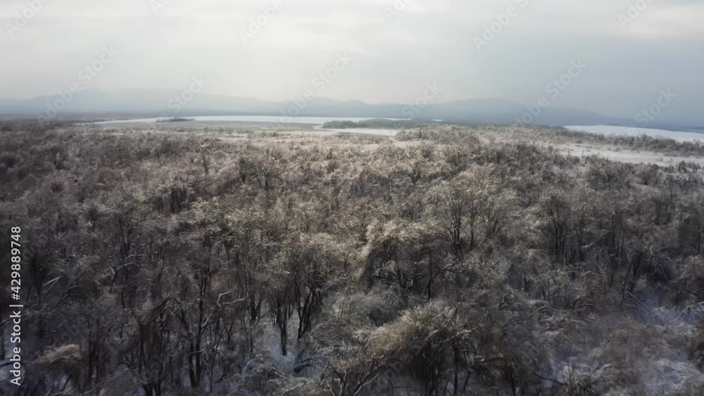 Close-up view from a drone to the ground covered with ice at sunset. Close-up view from a drone to the ground covered with ice at sunset.
