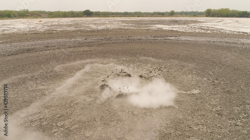 Mud volcano with bursting bubble bledug kuwu. aerial view volcanic plateau with geothermal activity and geysers, Indonesia java. aerial view volcanic landscape photo