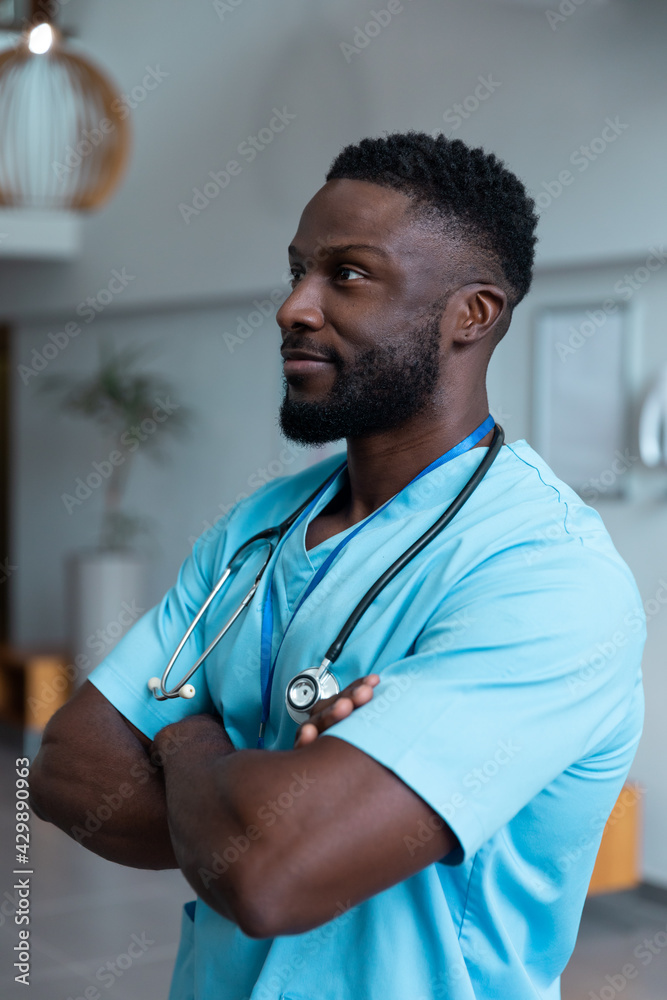 Portrait of african american male doctor with stethoscope wearing scrubs in hospital Portrait of african american male doctor with stethoscope wearing scrubs in hospital