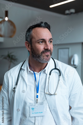 Portrait of caucasian male doctor with stethoscope wearing lab coat in hospital